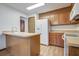 Functional kitchen with wood cabinets, a breakfast bar, and essential appliances for easy meal preparation at 436 Fox Hunt Rd, Goose Creek, SC 29445