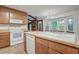 Bright kitchen featuring wood cabinets, white appliances, and a large sink, ideal for Gathering cooking at 436 Fox Hunt Rd, Goose Creek, SC 29445