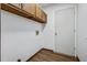 Laundry room featuring overhead cabinets, hardwood flooring, a white door, and a washer hook-up at 436 Fox Hunt Rd, Goose Creek, SC 29445