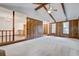 Large open living room with a vaulted ceiling, paneled walls, and bright kitchen view at 436 Fox Hunt Rd, Goose Creek, SC 29445