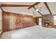 Spacious living room with a fireplace, wood paneled walls, ceiling fan and plush carpet at 436 Fox Hunt Rd, Goose Creek, SC 29445