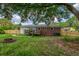 The backyard has a deck, brick back of house, and lots of trees for shade and privacy at 444 Clarine Dr, Goose Creek, SC 29445