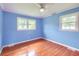 Cozy bedroom with hardwood floors, ceiling fan, and natural light from two windows at 444 Clarine Dr, Goose Creek, SC 29445