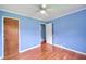 Simple bedroom with hardwood floors, ceiling fan, and an open doorway at 444 Clarine Dr, Goose Creek, SC 29445