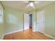 Bedroom featuring hardwood floors, ceiling fan, two doors, and natural light from a window at 444 Clarine Dr, Goose Creek, SC 29445