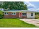 Home's inviting brick and siding facade with a bright red front door at 444 Clarine Dr, Goose Creek, SC 29445