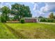 Charming brick home featuring a vibrant green lawn and mature trees for shade at 444 Clarine Dr, Goose Creek, SC 29445
