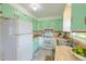 Charming kitchen featuring vintage mint green cabinets and a white appliance suite at 444 Clarine Dr, Goose Creek, SC 29445
