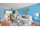 Cozy living room featuring bright blue walls, stylish decor, and natural light at 444 Clarine Dr, Goose Creek, SC 29445