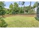 View of large green backyard with wooden fence and mature trees at 448 Jardinere Walk, Mount Pleasant, SC 29464