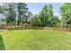 Large, well-maintained backyard with lush green grass and a wooden fence at 448 Jardinere Walk, Mount Pleasant, SC 29464