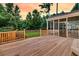 Spacious backyard deck with a screened-in porch overlooking lush greenery at 448 Jardinere Walk, Mount Pleasant, SC 29464