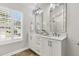 Bathroom featuring double sinks, elegant lighting and a window offering natural light at 448 Jardinere Walk, Mount Pleasant, SC 29464