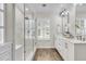 Modern bathroom featuring a glass shower, double sinks, and elegant fixtures at 448 Jardinere Walk, Mount Pleasant, SC 29464
