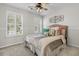 Comfortable bedroom with bright windows, ceiling fan, and stylish wall decor at 448 Jardinere Walk, Mount Pleasant, SC 29464