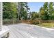 Large wooden deck with railings overlooks fenced backyard with mature trees at 448 Jardinere Walk, Mount Pleasant, SC 29464