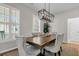 Stylish dining room boasting a modern chandelier, plantation shutters and seating for six at 448 Jardinere Walk, Mount Pleasant, SC 29464