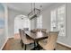 Elegant dining room featuring a modern chandelier and plantation shutters at 448 Jardinere Walk, Mount Pleasant, SC 29464