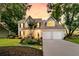 Charming home featuring a landscaped yard, two-car garage, and inviting front porch at 448 Jardinere Walk, Mount Pleasant, SC 29464