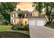 Charming two-story home with a well-manicured lawn and a two-car garage at 448 Jardinere Walk, Mount Pleasant, SC 29464