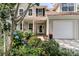 Inviting home exterior with charming front porch and beautiful flowering landscaping at 448 Jardinere Walk, Mount Pleasant, SC 29464