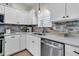 Updated kitchen features stainless steel appliances, white cabinets and stunning brick backsplash at 448 Jardinere Walk, Mount Pleasant, SC 29464