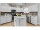 Modern kitchen with white cabinets, stainless steel appliances, brick backsplash and marble countertops at 448 Jardinere Walk, Mount Pleasant, SC 29464
