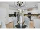 Bright eat-in kitchen features white cabinets, stainless steel appliances, stylish backsplash and modern chandelier at 448 Jardinere Walk, Mount Pleasant, SC 29464
