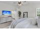 Bright main bedroom with a TV, modern ceiling fan and an en suite bathroom at 448 Jardinere Walk, Mount Pleasant, SC 29464