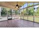 Interior of screened-in porch with fan, hanging lights, and view of fenced backyard at 448 Jardinere Walk, Mount Pleasant, SC 29464