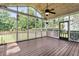 Interior view of a screened-in porch with ceiling fan and hanging lights overlooking the backyard at 448 Jardinere Walk, Mount Pleasant, SC 29464