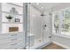 Modern glass shower with window and seating inside, next to built-in shelving at 448 Jardinere Walk, Mount Pleasant, SC 29464