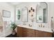Elegant bathroom with double sinks, decorative lighting, and a green plant adding a fresh touch at 4620 O'Hear Ave, North Charleston, SC 29405