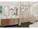 Luxurious bathroom featuring a double vanity with modern fixtures, arched mirrors, and a glass-enclosed shower at 4620 O'Hear Ave, North Charleston, SC 29405