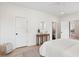 Minimalist bedroom featuring white walls, a round mirror, and a wooden console table with decorative items at 4620 O'Hear Ave, North Charleston, SC 29405