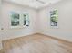 Bright bedroom with hardwood floors, three large windows, and minimal decor at 4620 O'Hear Ave, North Charleston, SC 29405