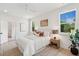 Bright bedroom with neutral decor, including a ceiling fan and bedside tables on either side of the bed at 4620 O'Hear Ave, North Charleston, SC 29405
