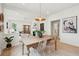 Open-concept home featuring a dining area with wicker chairs, a decorative light fixture, and a fireplace at 4620 O'Hear Ave, North Charleston, SC 29405