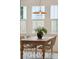 Sun-filled dining area boasts modern lighting, a wooden table, and stylish wicker chairs near bright windows at 4620 O'Hear Ave, North Charleston, SC 29405