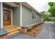 Charming home exterior with a wood door, siding, and landscaped gravel pathway at 4620 O'Hear Ave, North Charleston, SC 29405