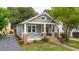 Quaint home with a welcoming front porch, brick accents, and lush landscaping for curb appeal at 4620 O'Hear Ave, North Charleston, SC 29405