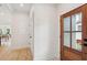 Hallway features patterned flooring and wood door, leading into dining area, creating welcoming transition at 4620 O'Hear Ave, North Charleston, SC 29405