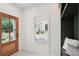 Entryway with decorative floor tiles, wood door and view into a bedroom filled with light at 4620 O'Hear Ave, North Charleston, SC 29405