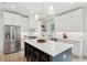 Bright kitchen featuring a center island with seating, stainless steel appliances, and white cabinets at 4620 O'Hear Ave, North Charleston, SC 29405