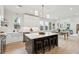Open-concept kitchen with island and seating, adjacent dining area, bright white cabinets and stainless appliances at 4620 O'Hear Ave, North Charleston, SC 29405