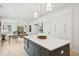 Bright kitchen features an island with quartz countertop and built-in appliances, with view to the dining area at 4620 O'Hear Ave, North Charleston, SC 29405