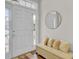 Charming foyer with wood floors, decorative mirror, seating and plenty of natural light at 469 Hainsworth Dr, Charleston, SC 29414