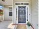 Inviting front porch featuring a welcome mat, plants, and a black paneled front door at 469 Hainsworth Dr, Charleston, SC 29414