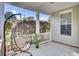Comfortable front porch showcasing a hanging chair, small plants and plenty of space for relaxation at 469 Hainsworth Dr, Charleston, SC 29414