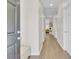 Bright hallway featuring hardwood floors, neutral walls, and a clear view to the living room at 469 Hainsworth Dr, Charleston, SC 29414